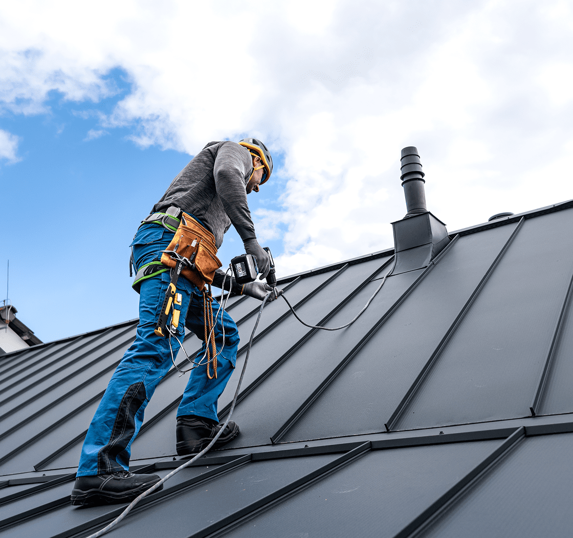 Worker installing roofing on a building. Worker installing roofing on a building.